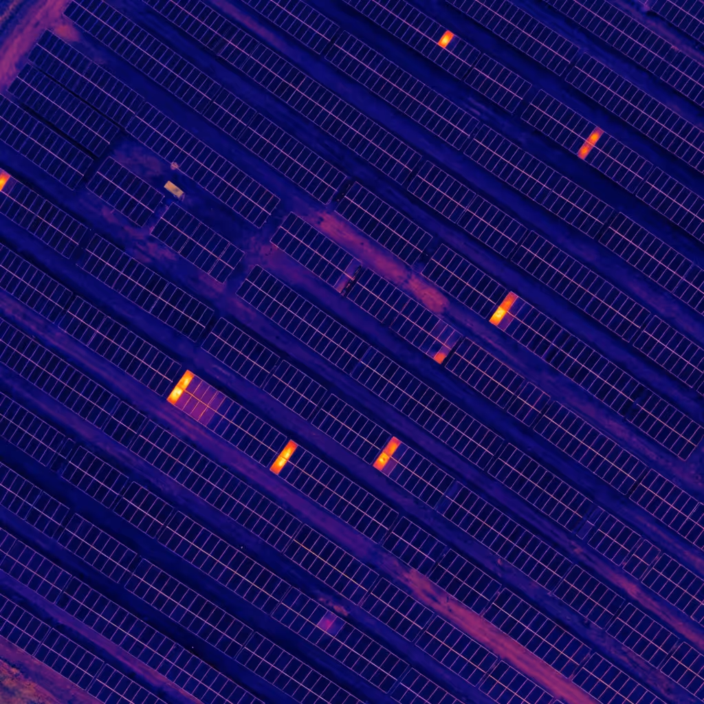 Solar PV field aerial showing module rows scanned autonomously for hotspots and soiling