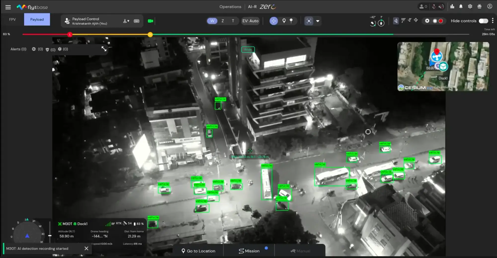 Drone thermal night view of a city intersection with vehicles detected and highlighted