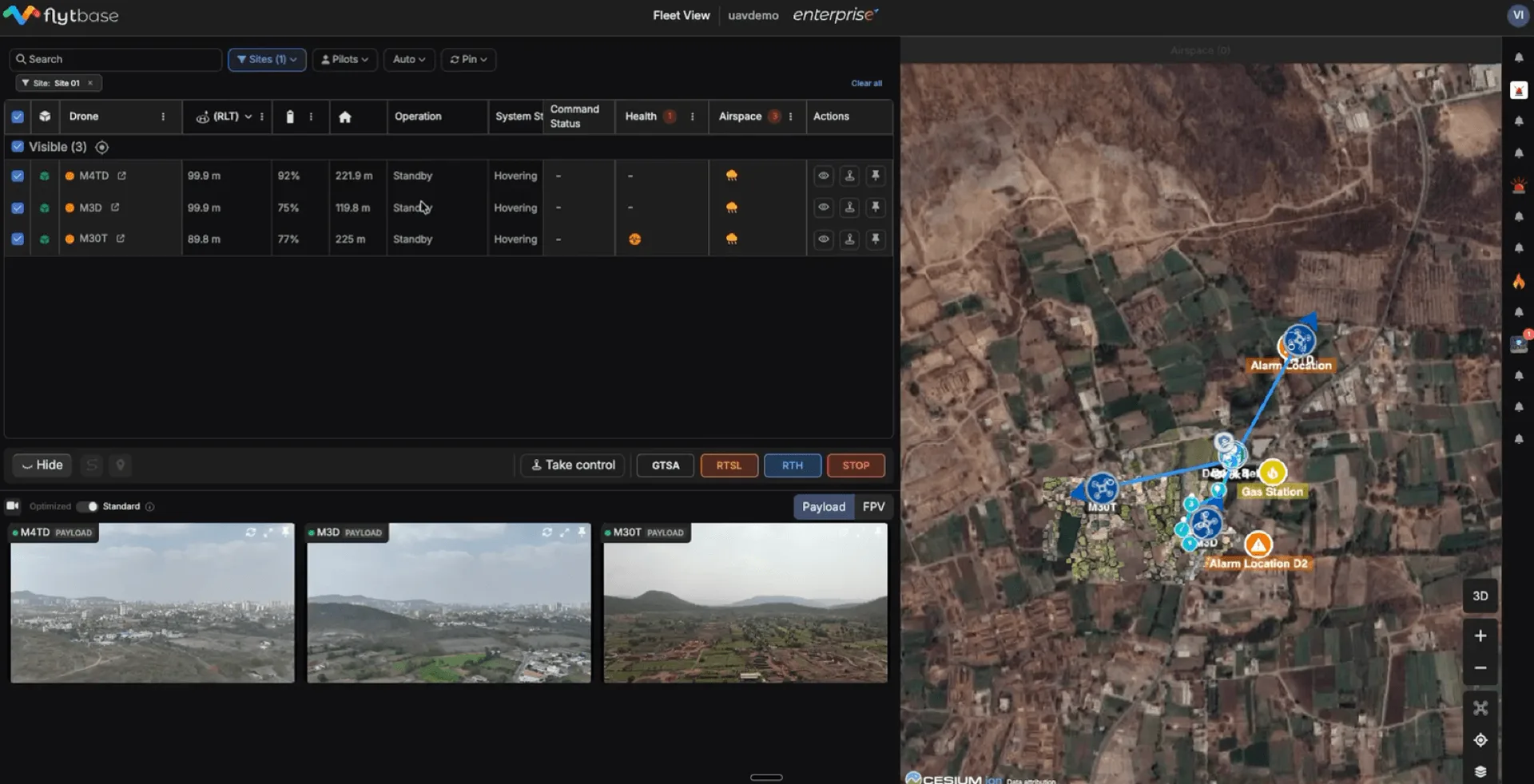 FlytBase Fleet View — multi-drone live telemetry table, video feeds, and Cesium map showing alarm locations