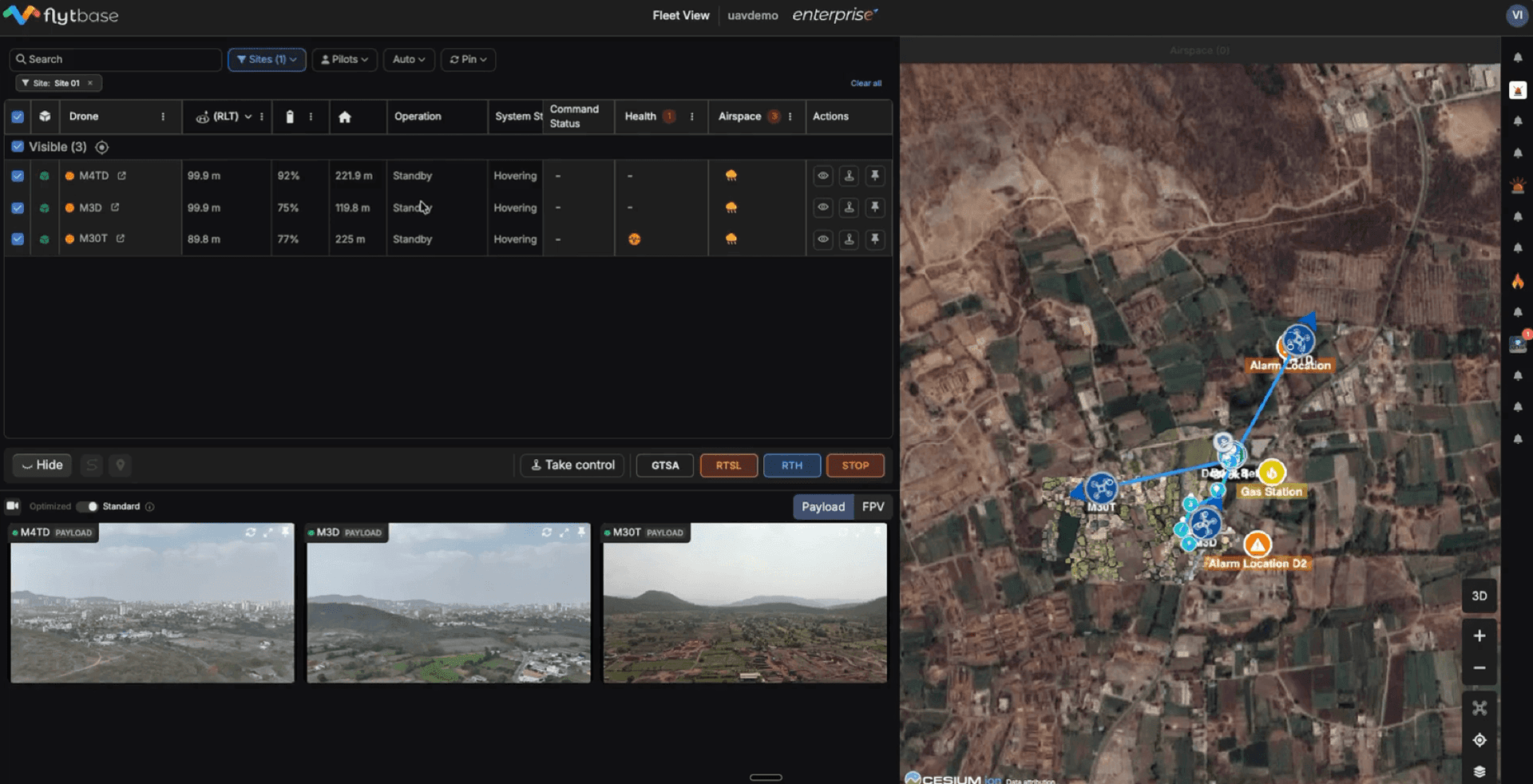 FlytBase Fleet View — multi-drone live telemetry table, video feeds, and Cesium map showing alarm locations