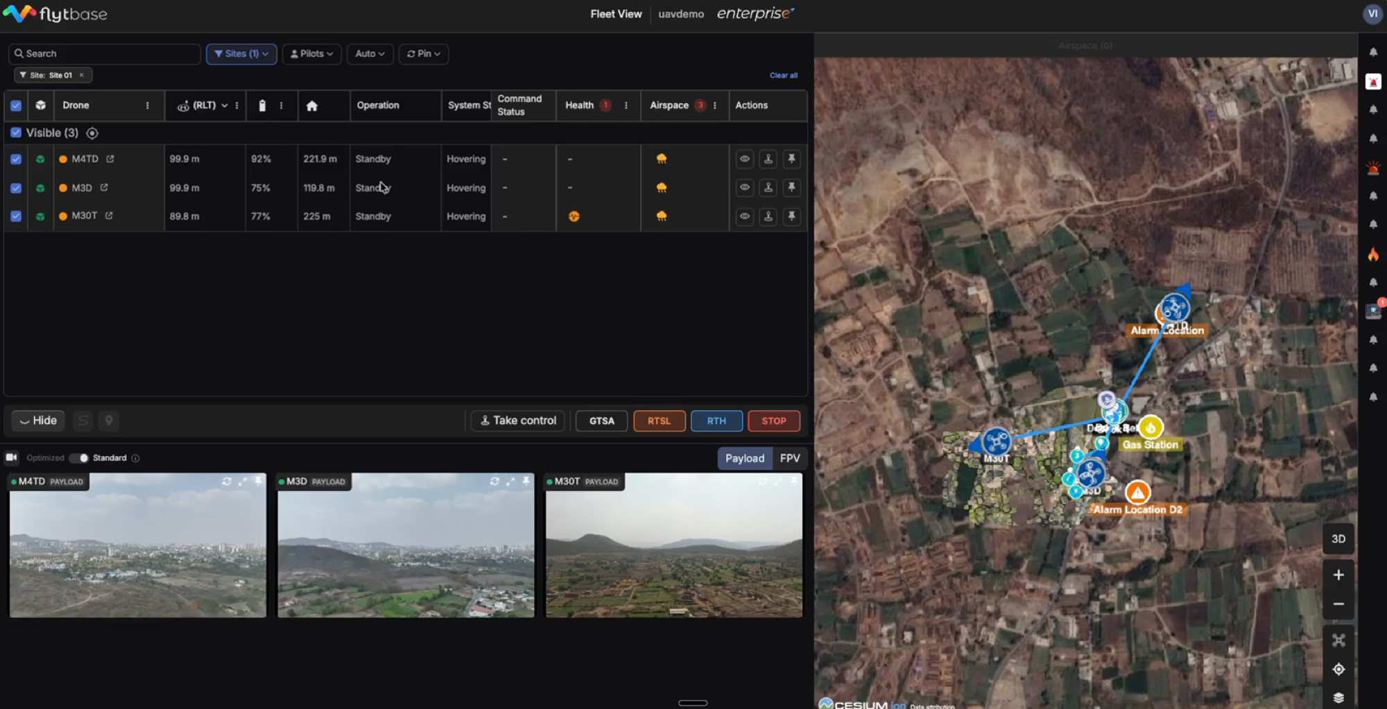 FlytBase Fleet View — multi-drone live telemetry table, video feeds, and Cesium map showing alarm locations